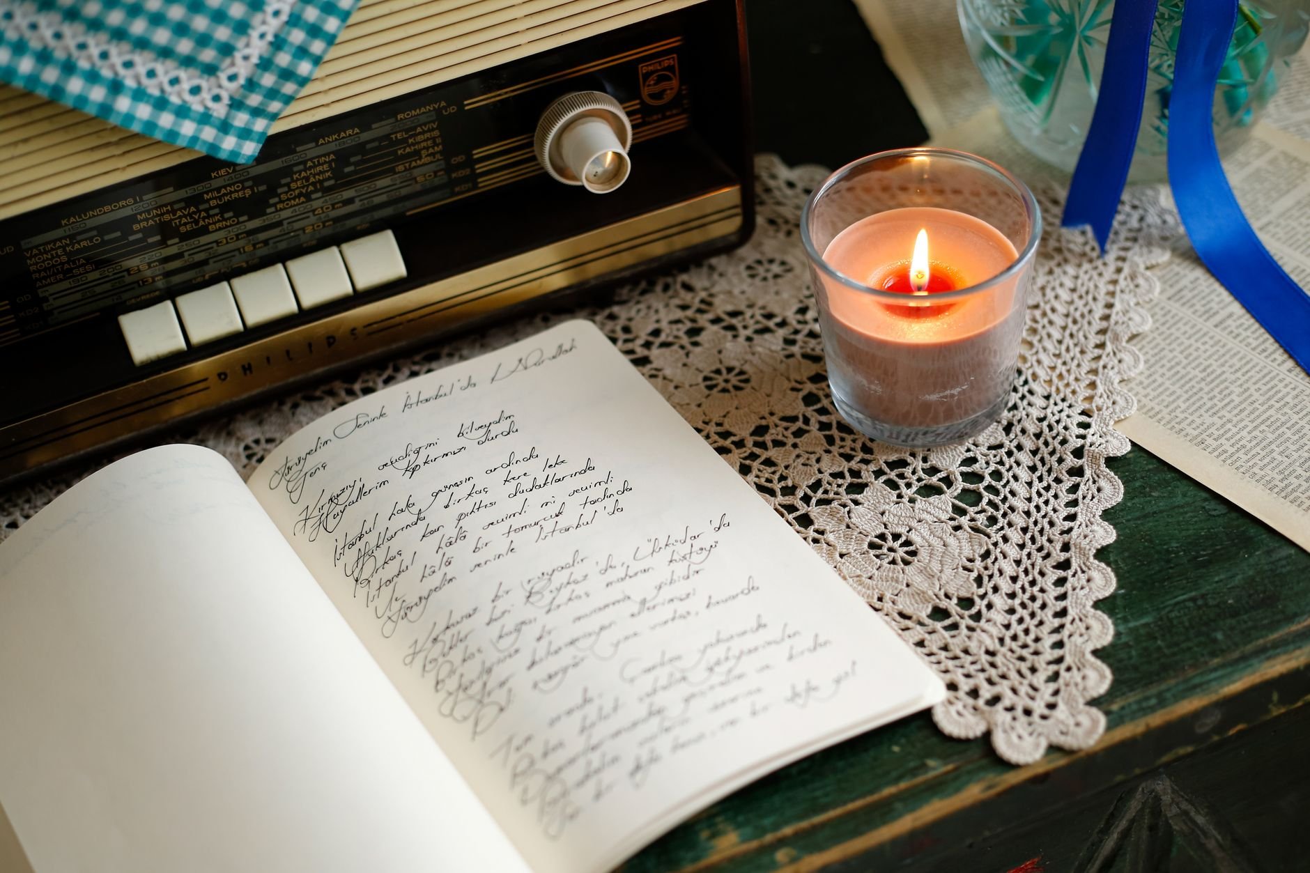 A cozy, candlelit journal and vintage scene — intimate and reflective